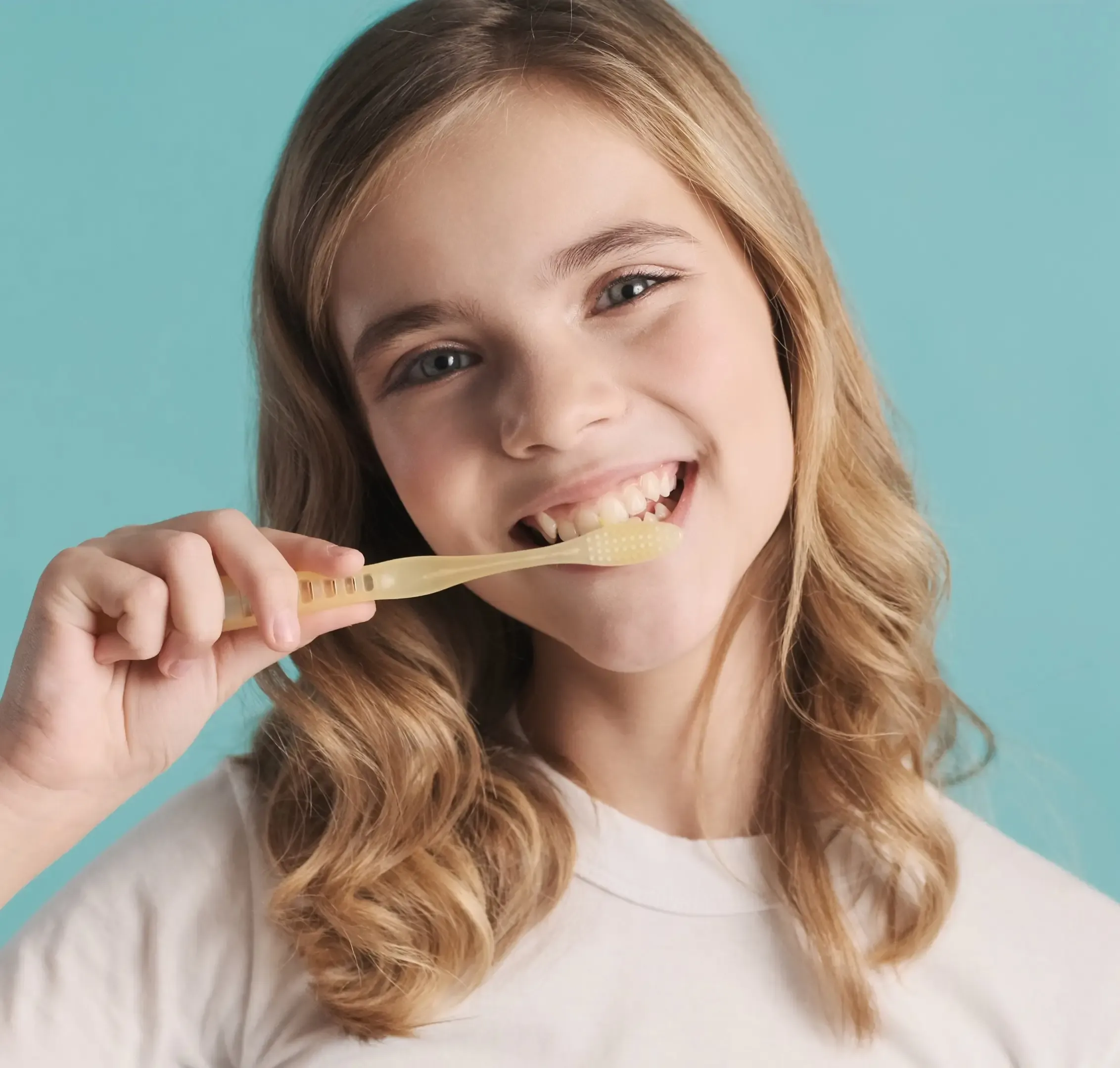 attractive-smiling-blond-teenage-girl-cleaning-her-teeth-camera-looking-happy-blue-background-webp